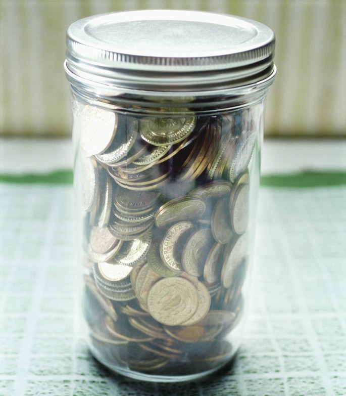 Coins in a Glass Jar --- Image by © Royalty-Free/Corbis